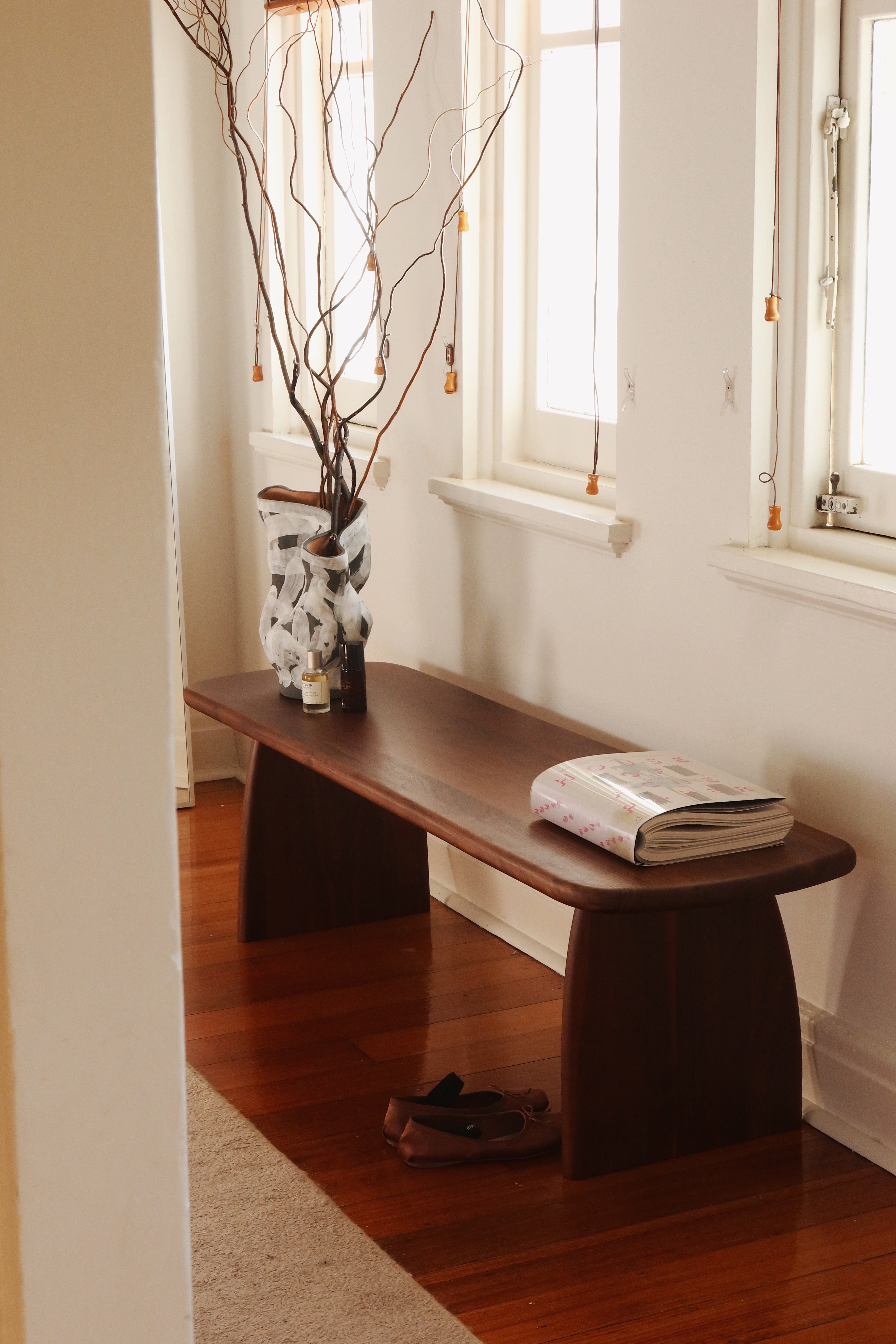 Walnut wood bench seat styled in a home