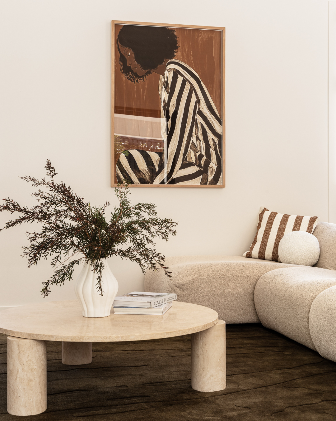 Living room styled with a cream travertine round coffee table
