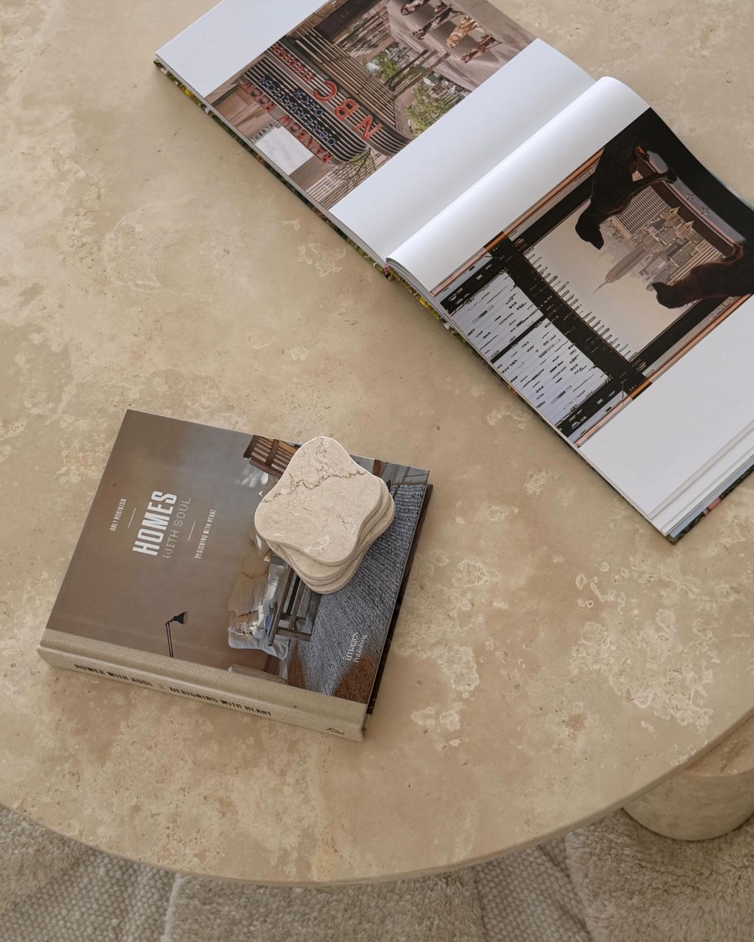 Round cream travertine coffee table styled