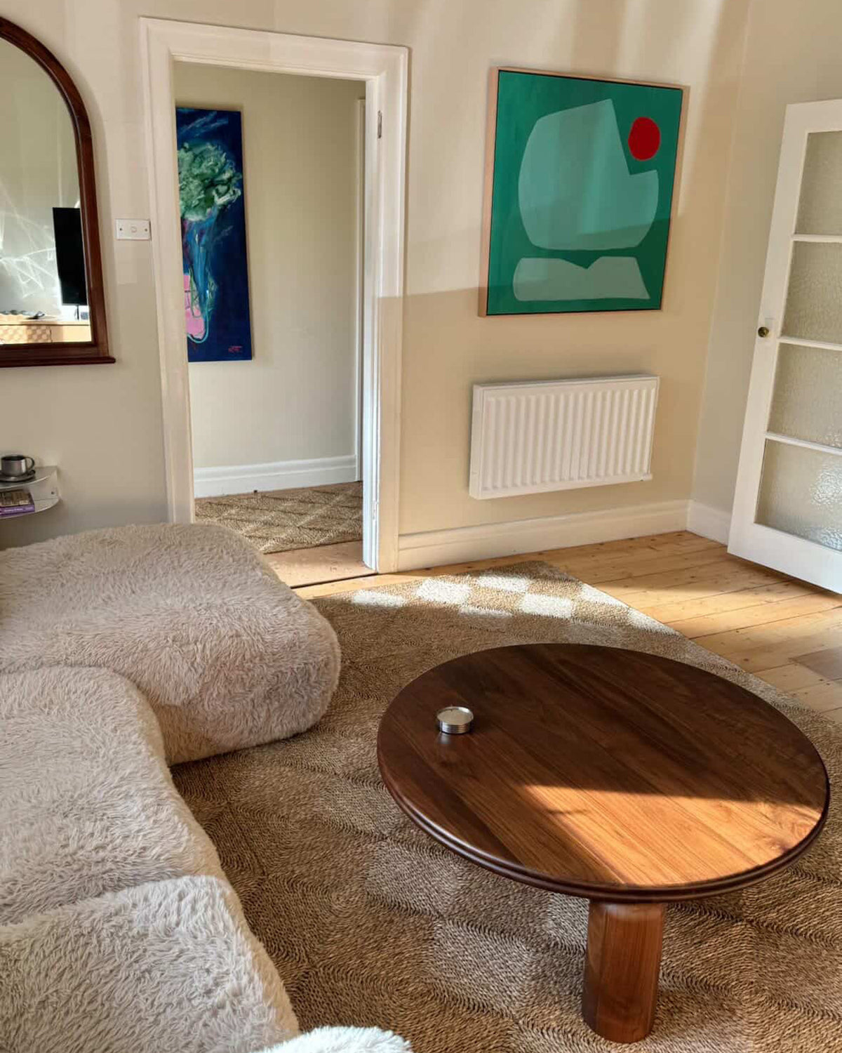Round walnut timber coffee table in a living room