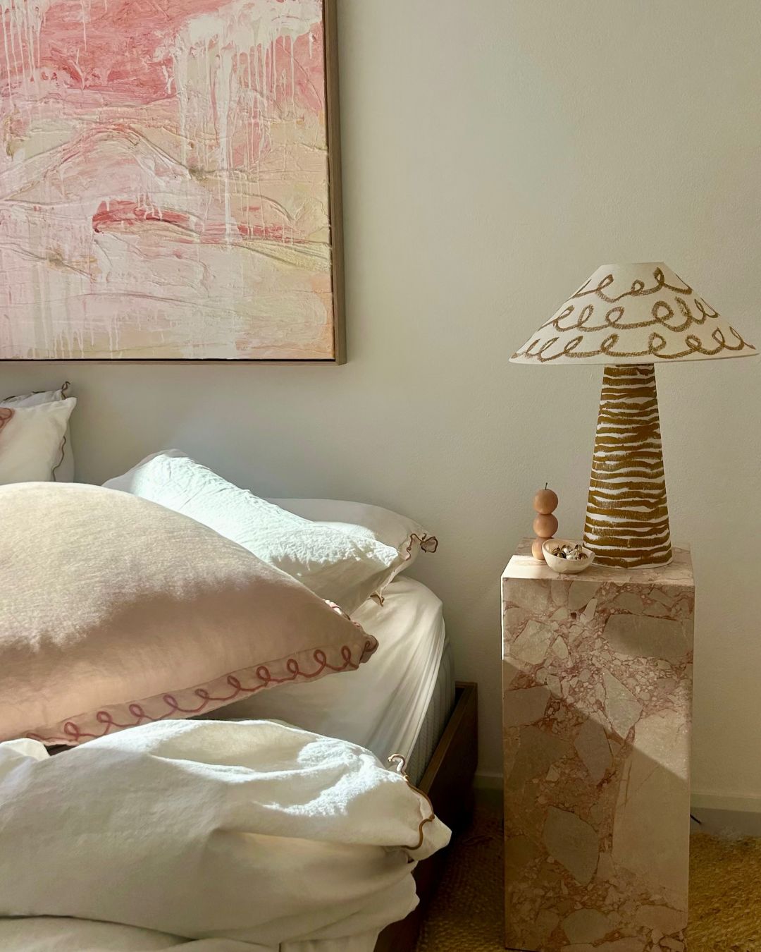 Marble plinth side table styled in a bedroom