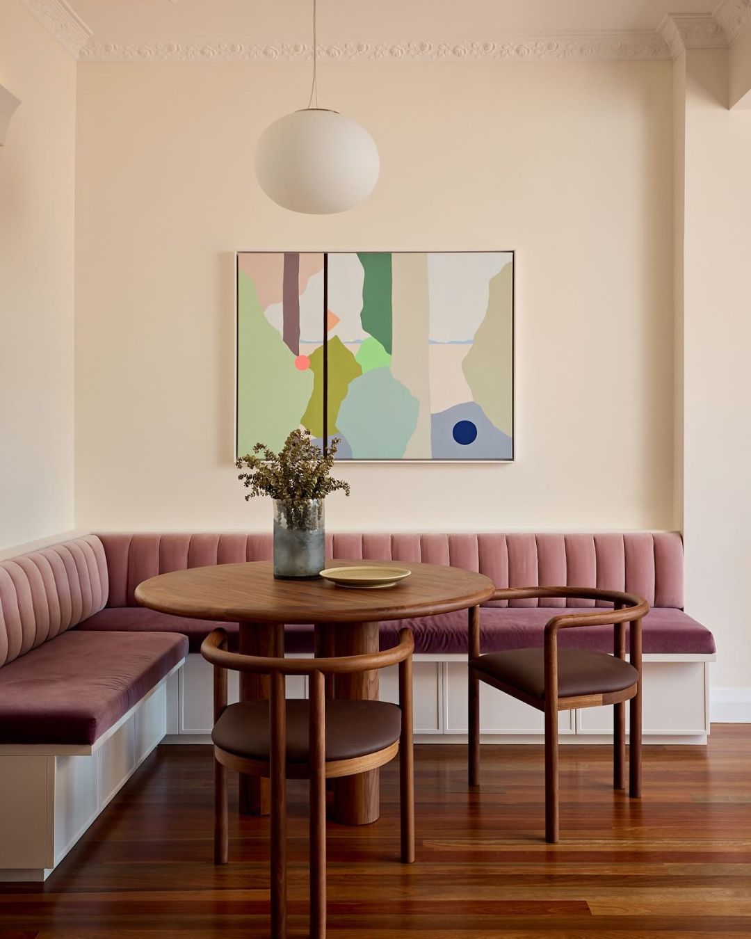 Walnut timber dining chairs in a dining room.