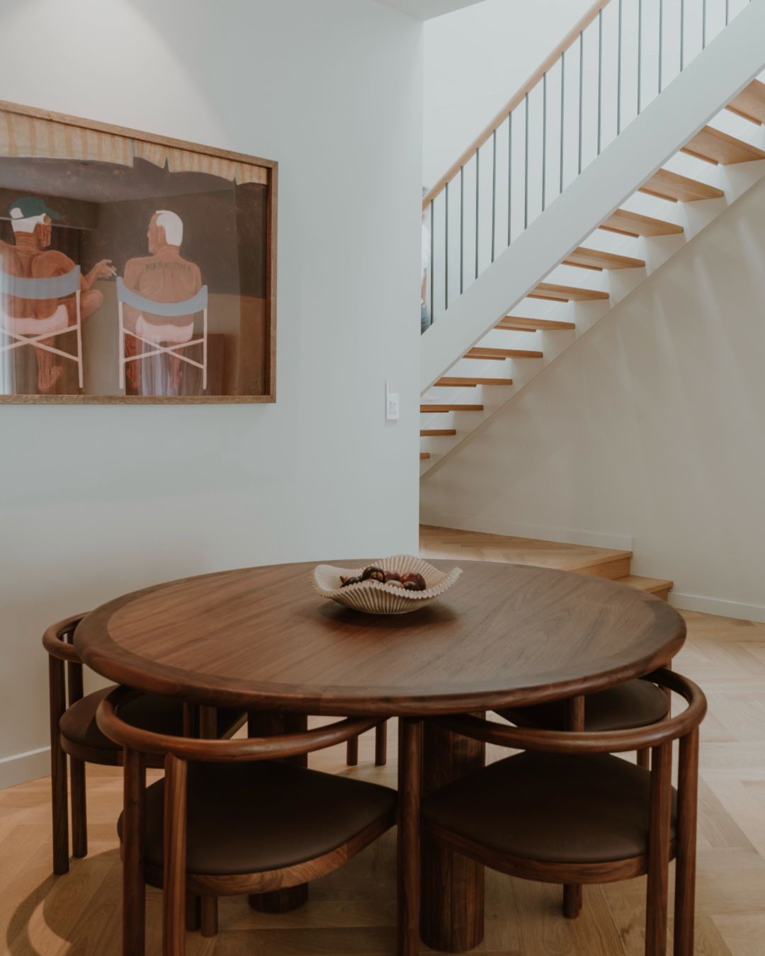 Walnut timber dining chairs in a dining room.