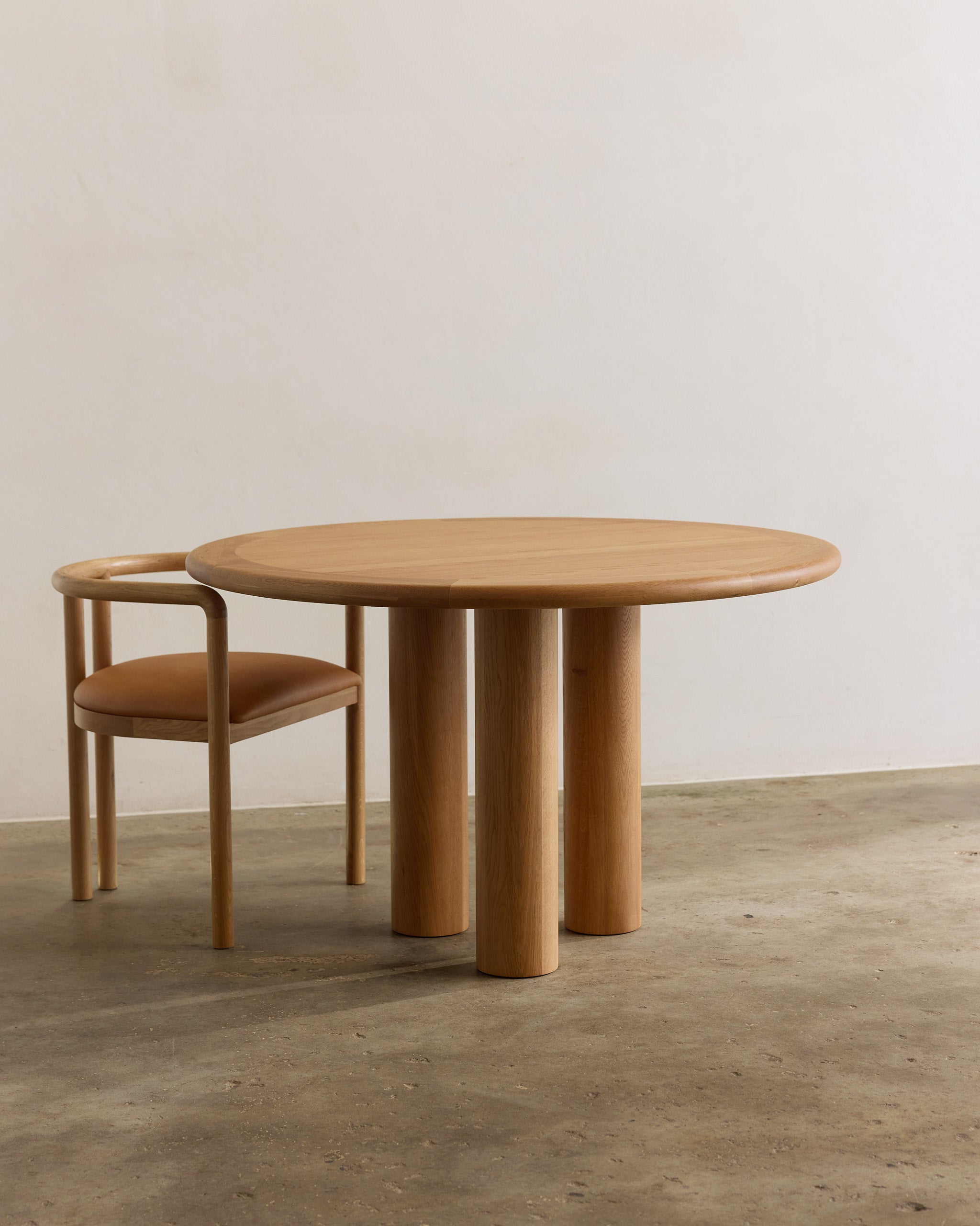 Round oak timber dining table and chair