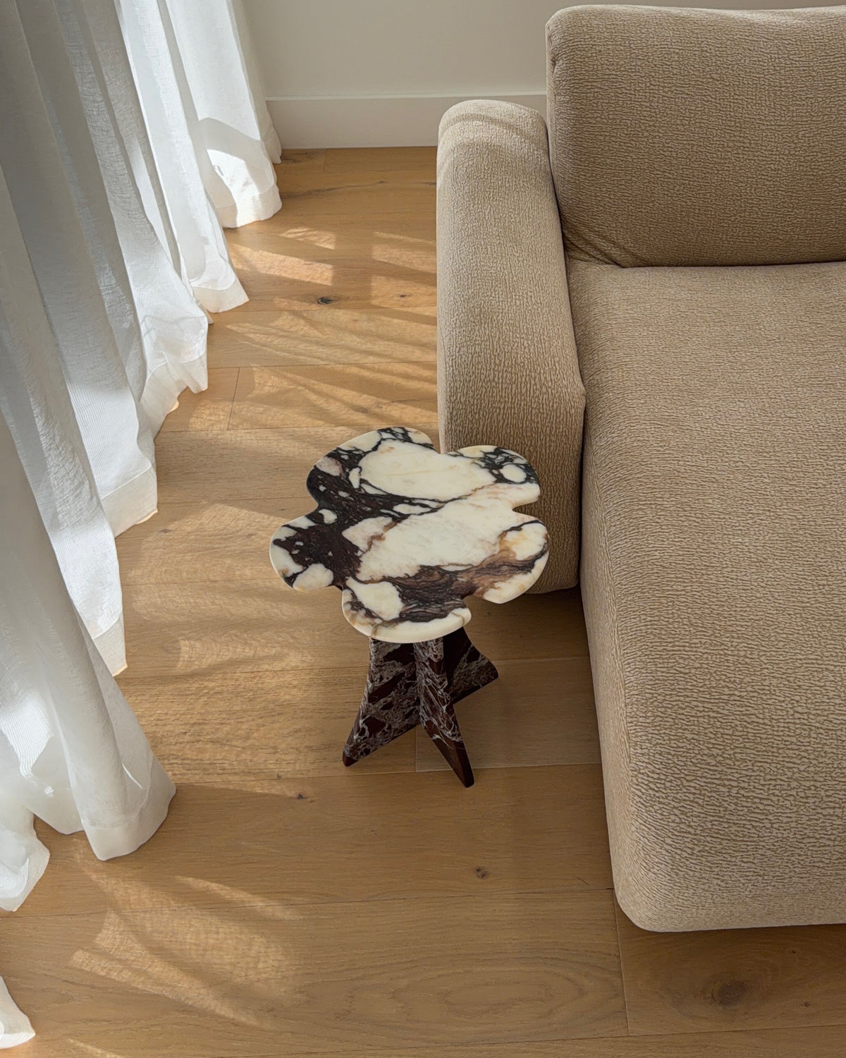 Marble side table next to a couch