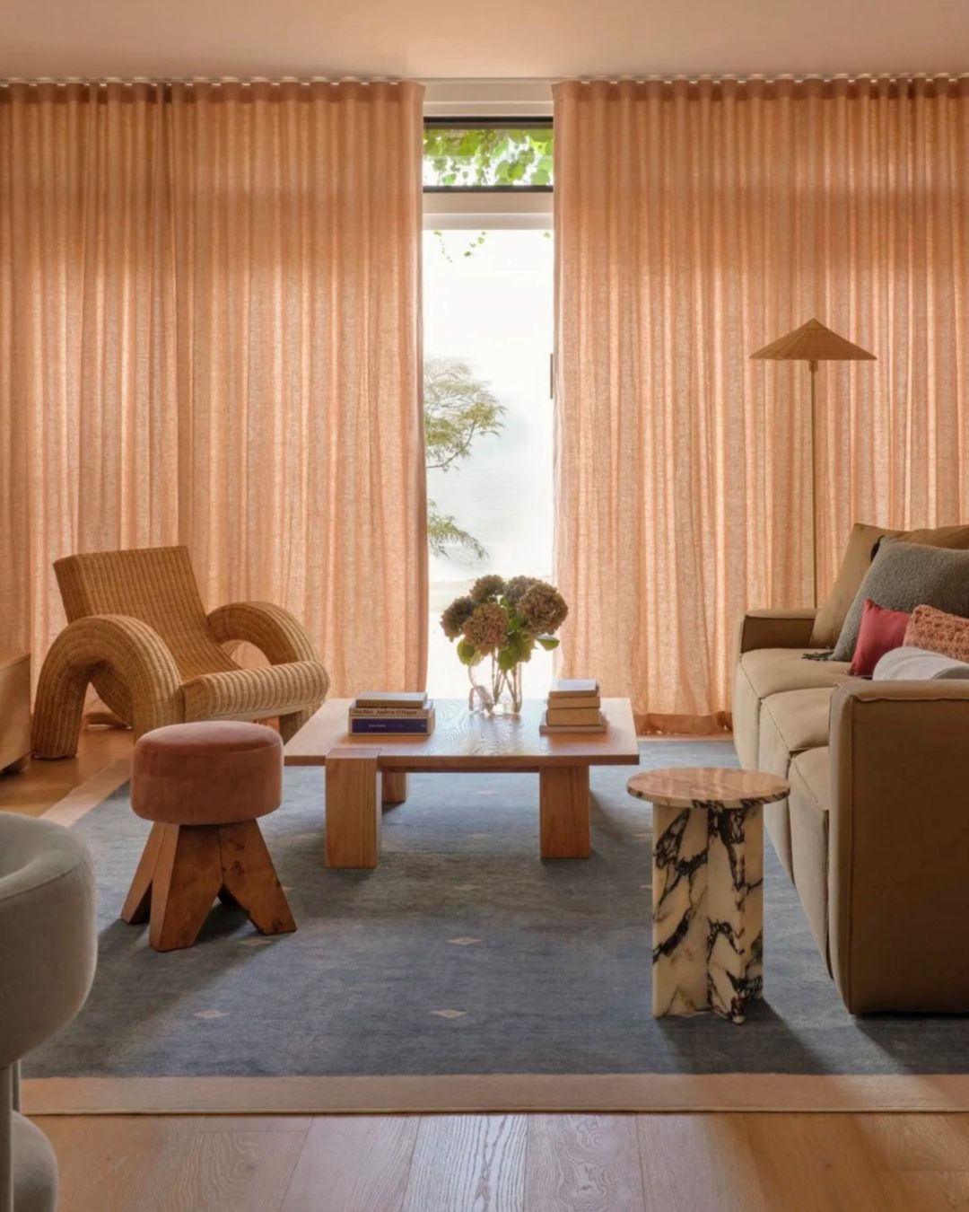 Living room styled with warm textures and a marble side table
