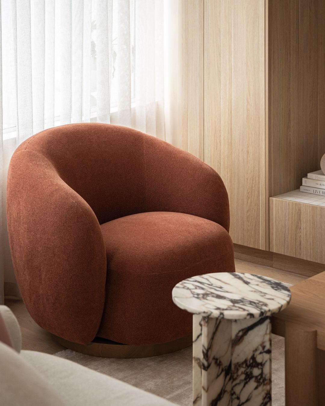 Small calacatta viola side table styled next to a lounge chair