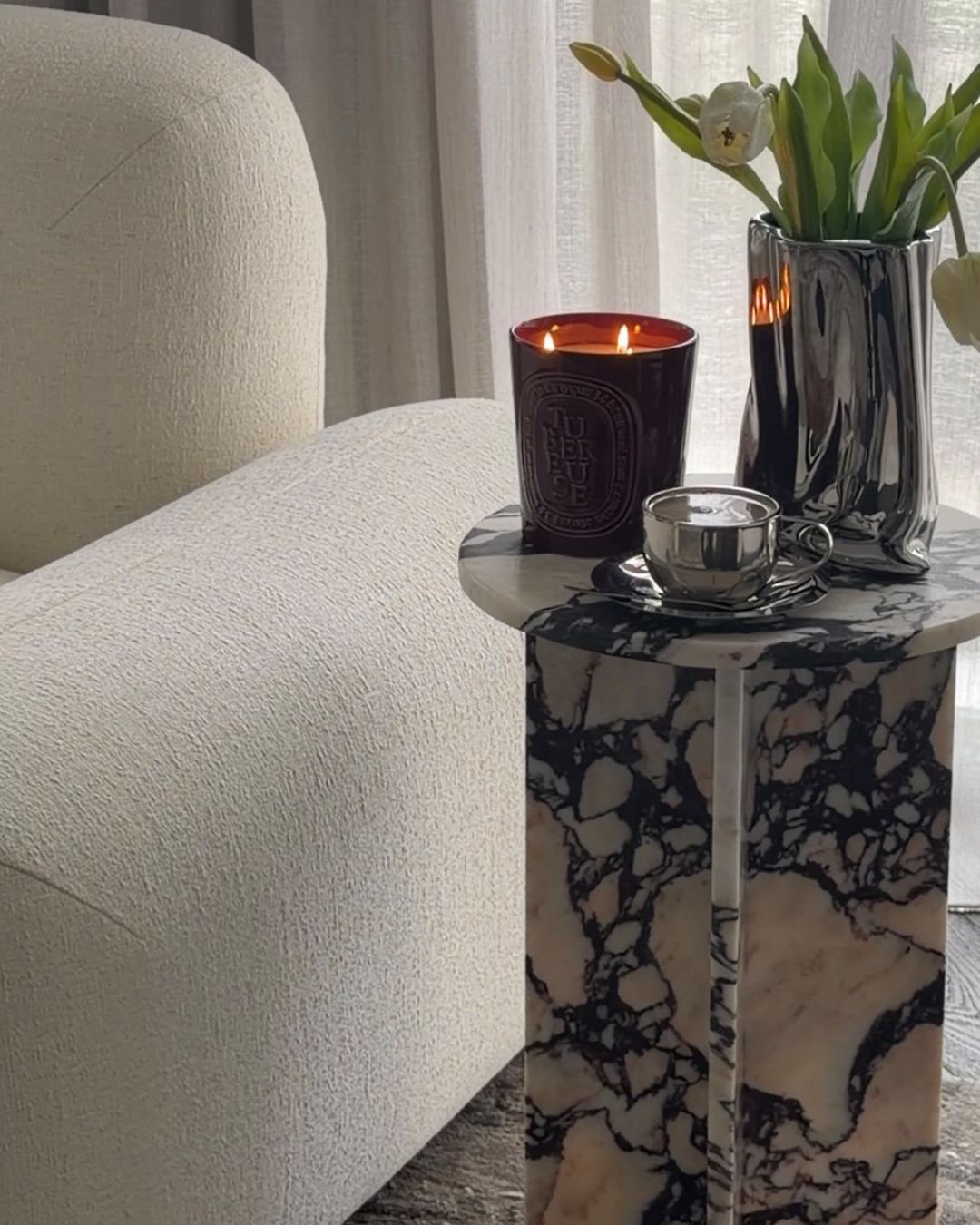 Small calacatta viola side table styled in a living room