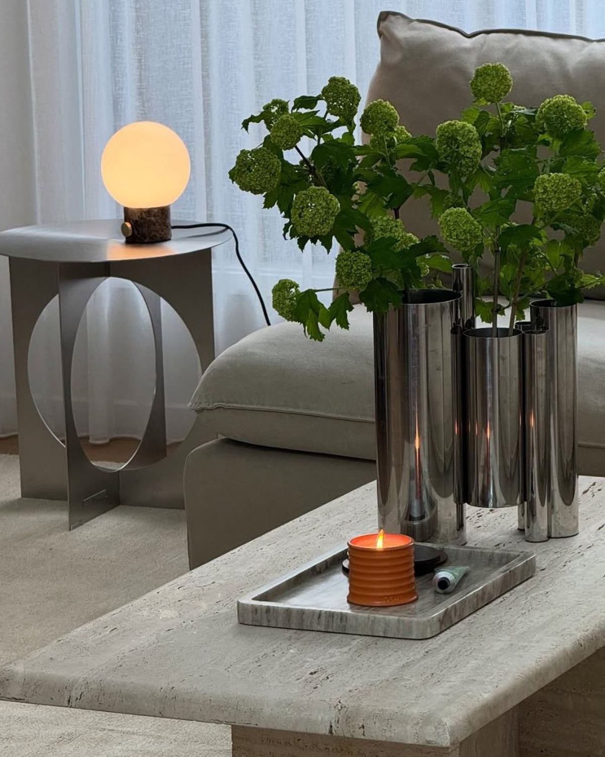 Stainless steel vase styled in a living room