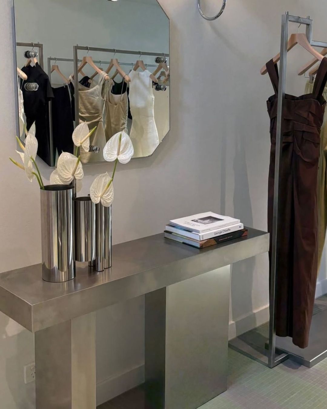 Stainless steel vase styled on a console table