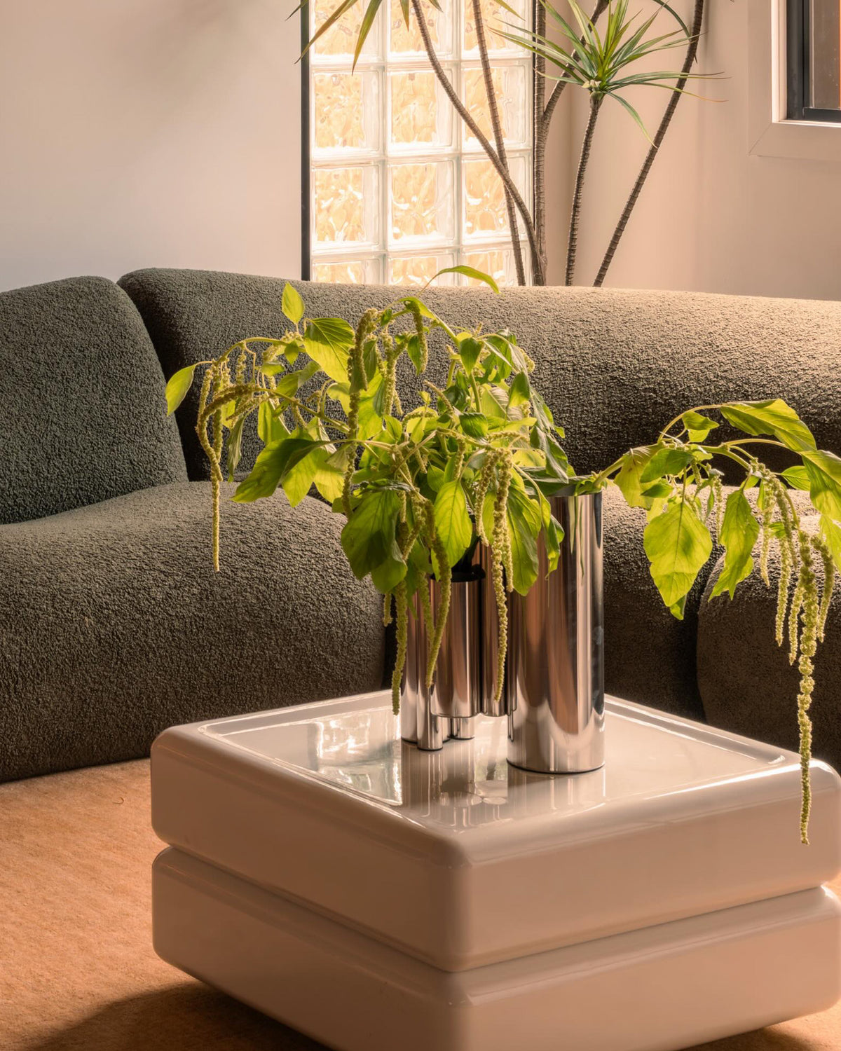 Stainless steel vase styled in a living room