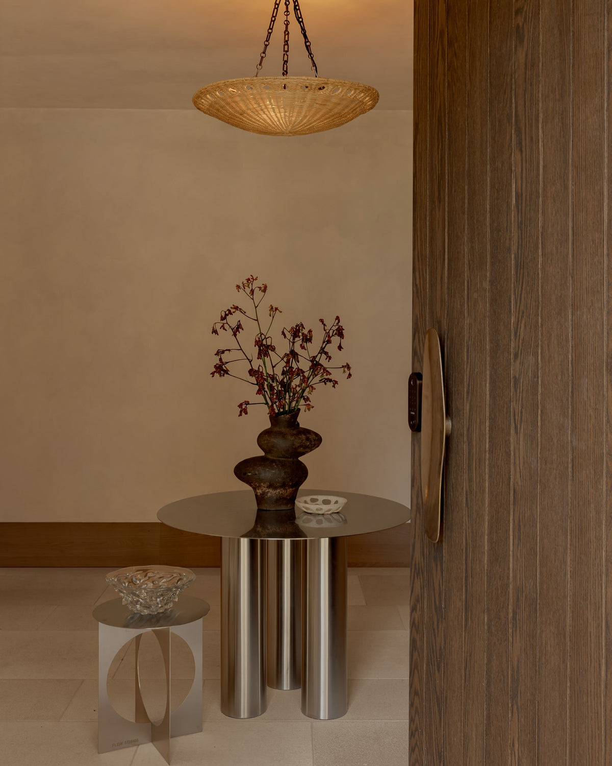 Stainless steel dining table and side table in an entryway