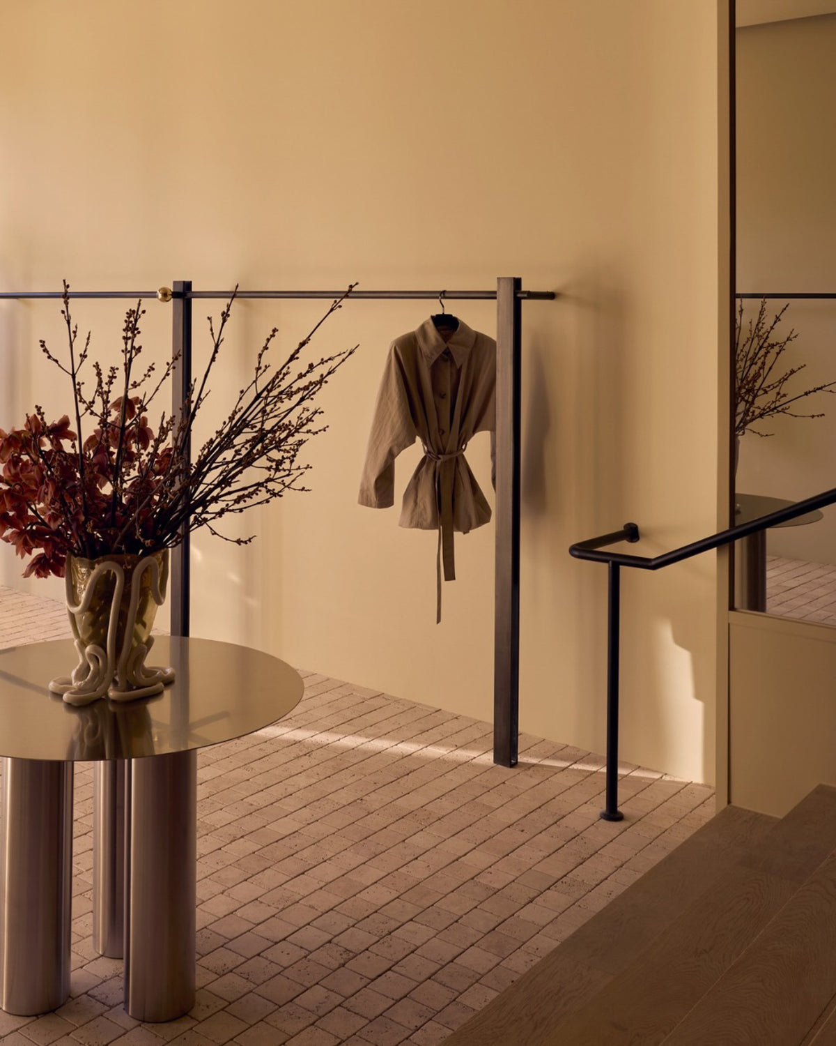 Stainless steel dining table styled in a boutique.