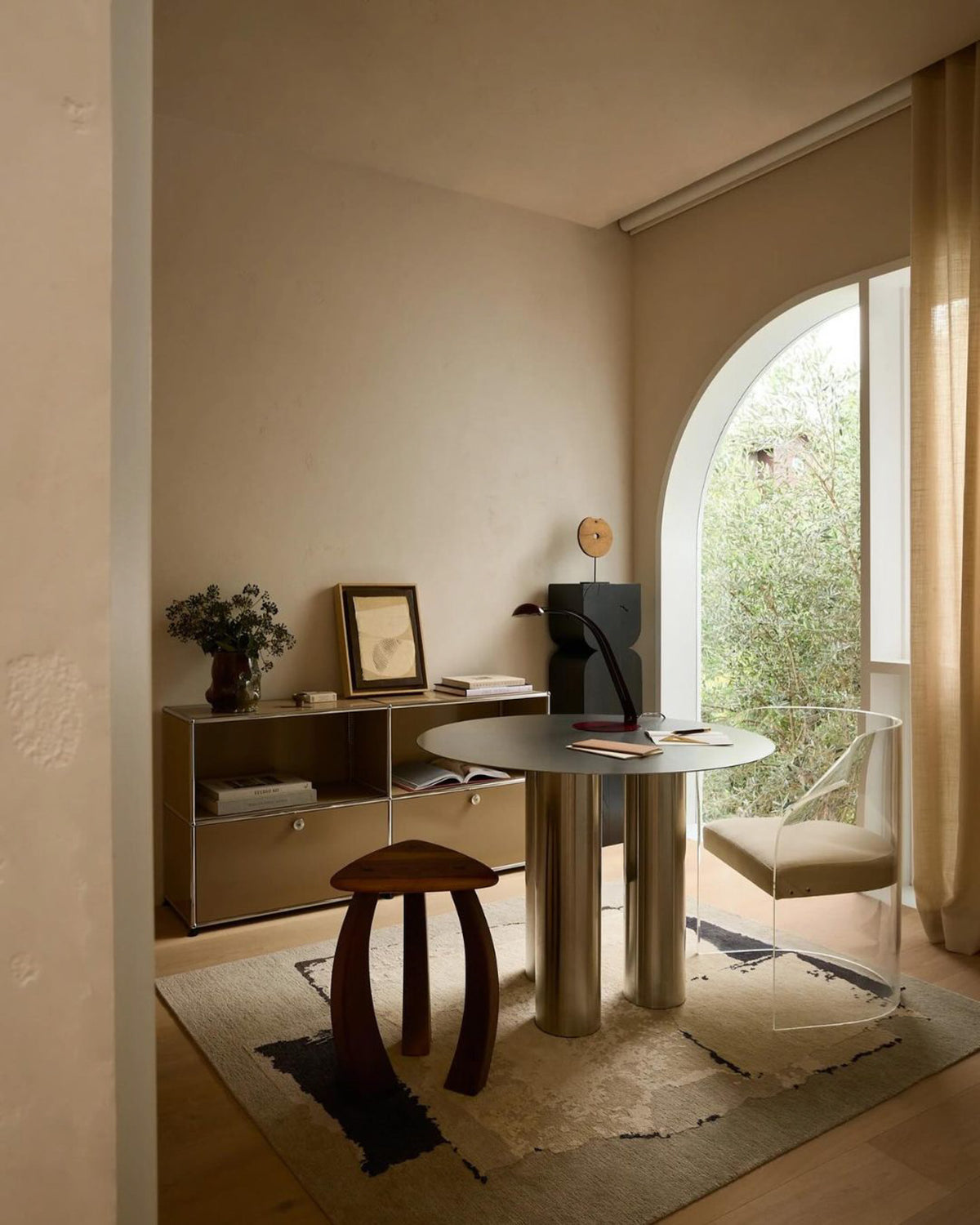Stainless steel dining table styled in an office.