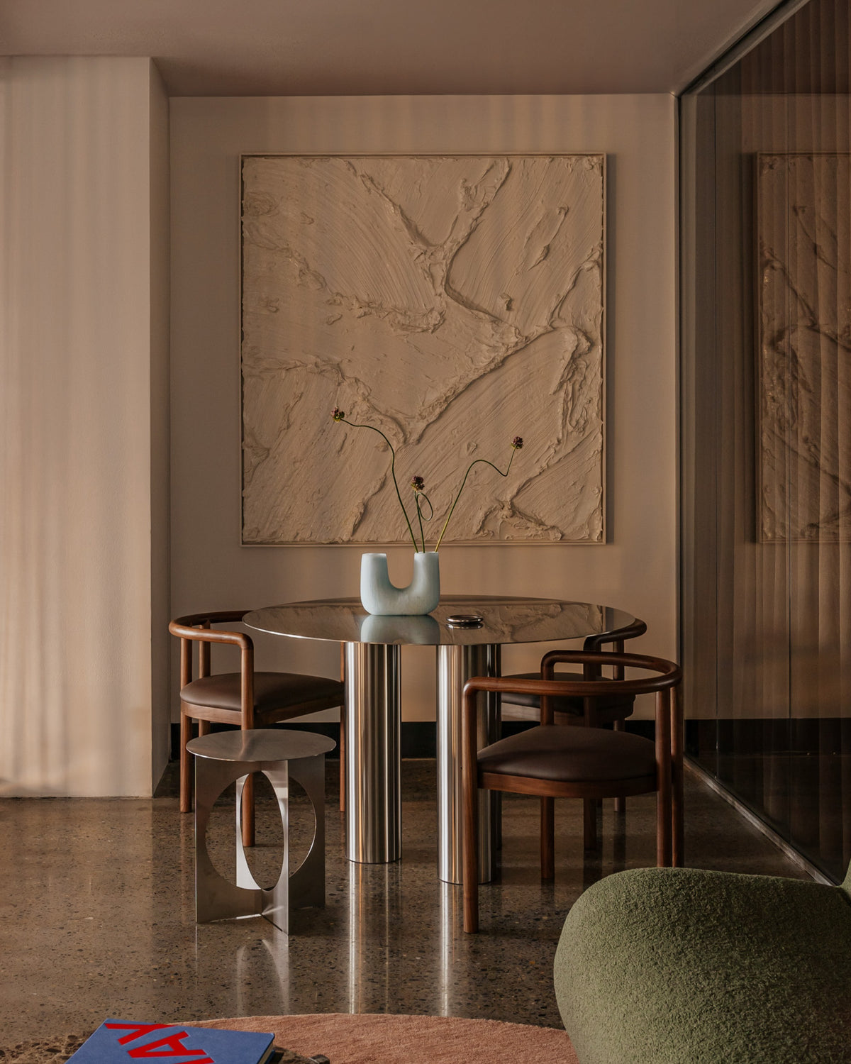 Modern dining room featuring a stainless steel dining table