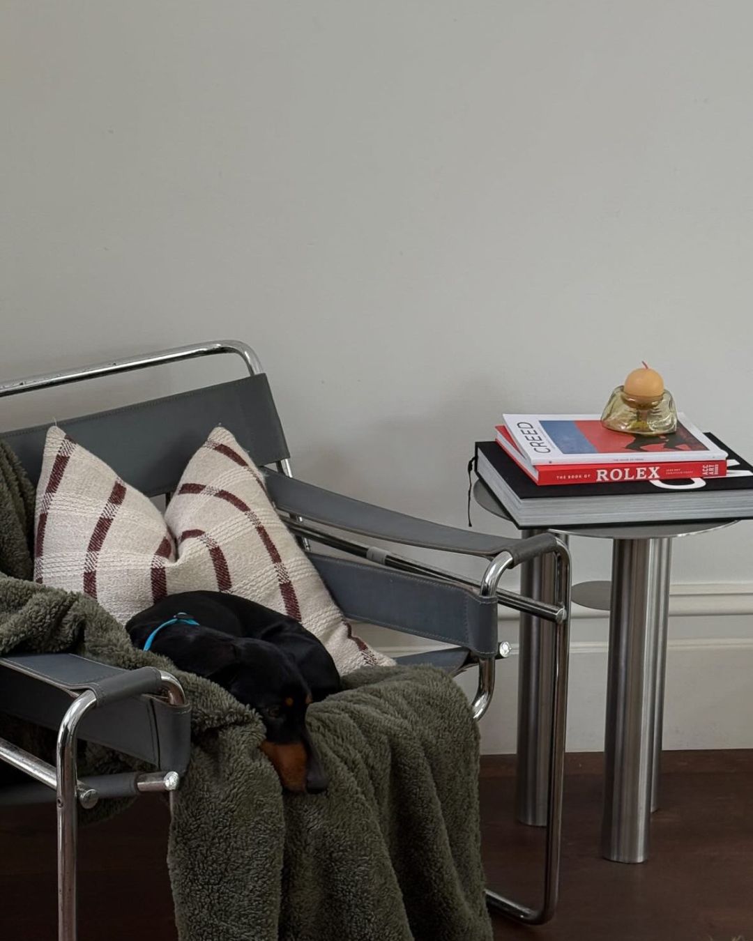 Modern chair next to a small side table.