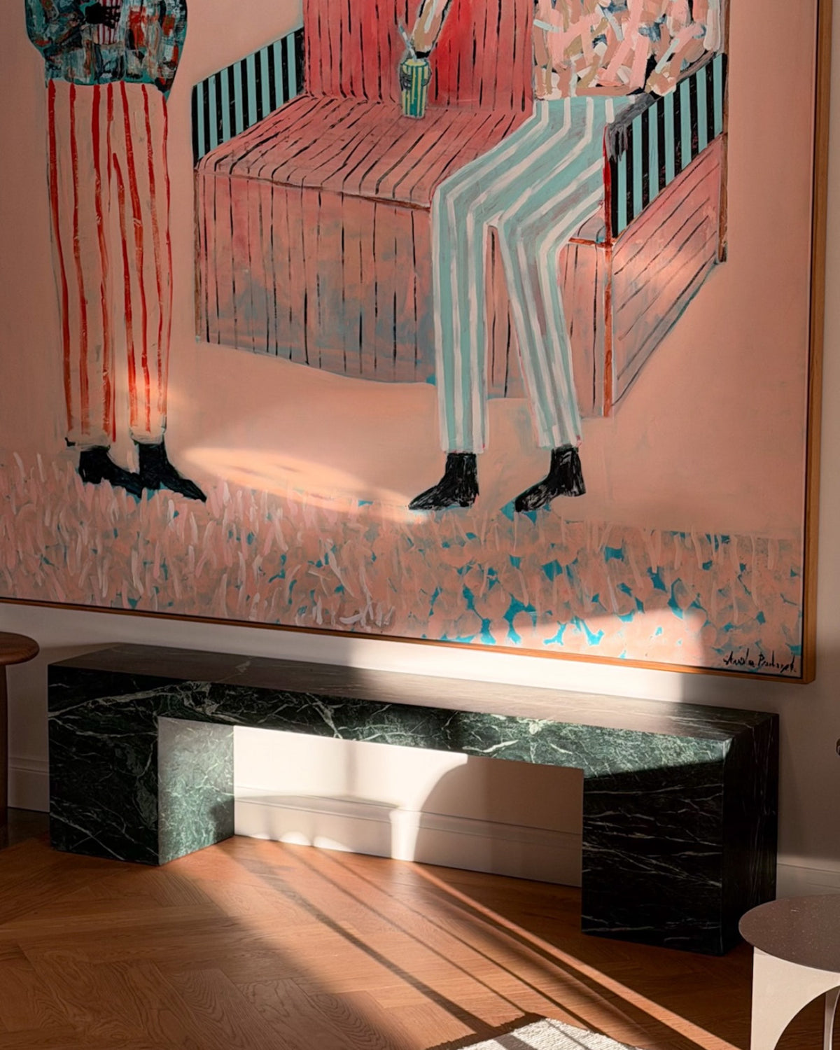Low verde bench seat styled beneath a painting