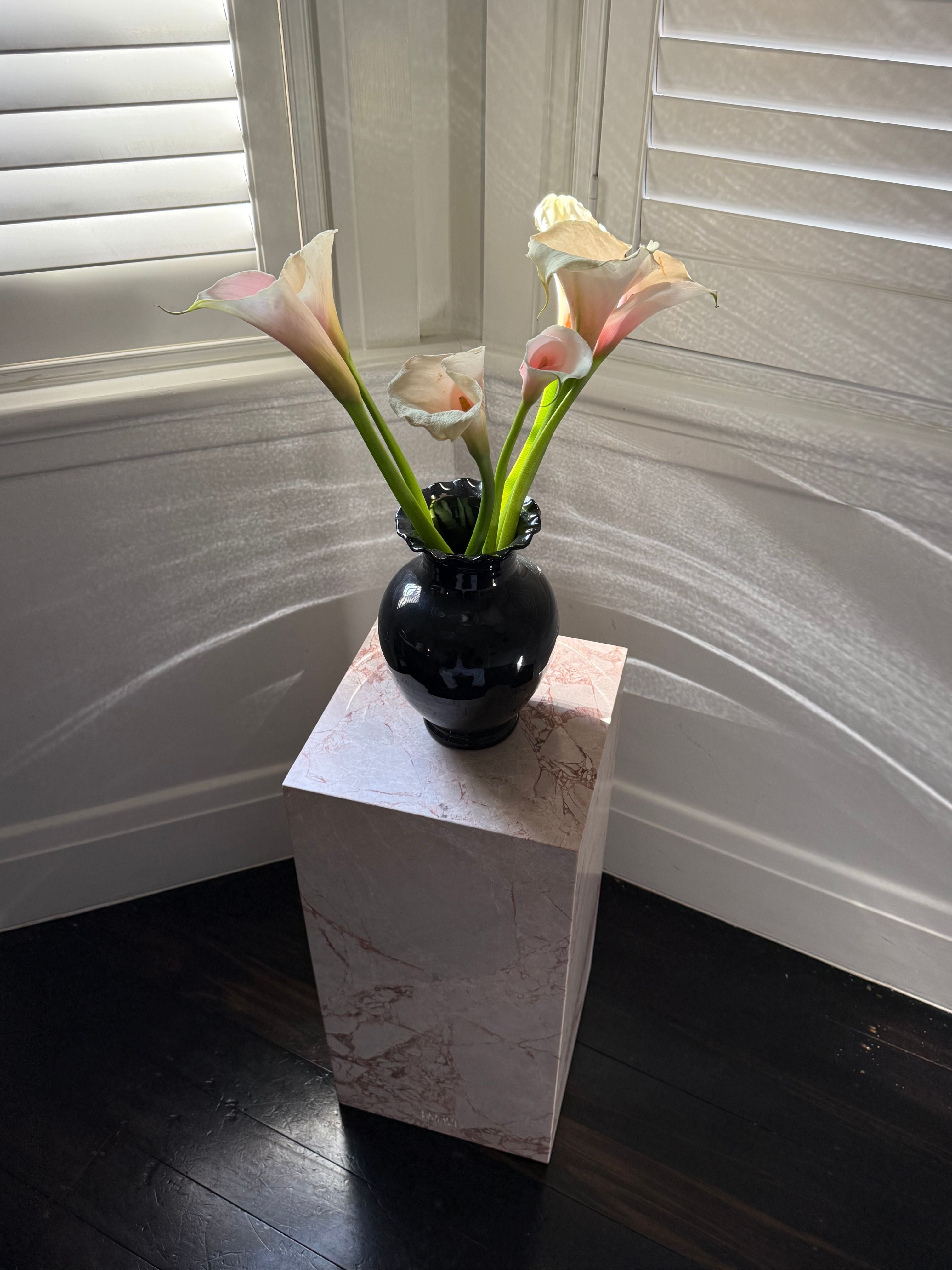 Marble plinth styled with a vase and flowers
