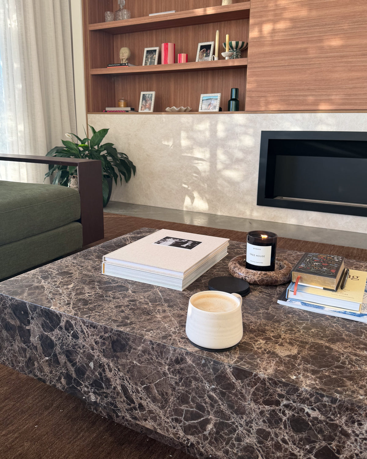 Chocolate marble coffee table styled in a living room.