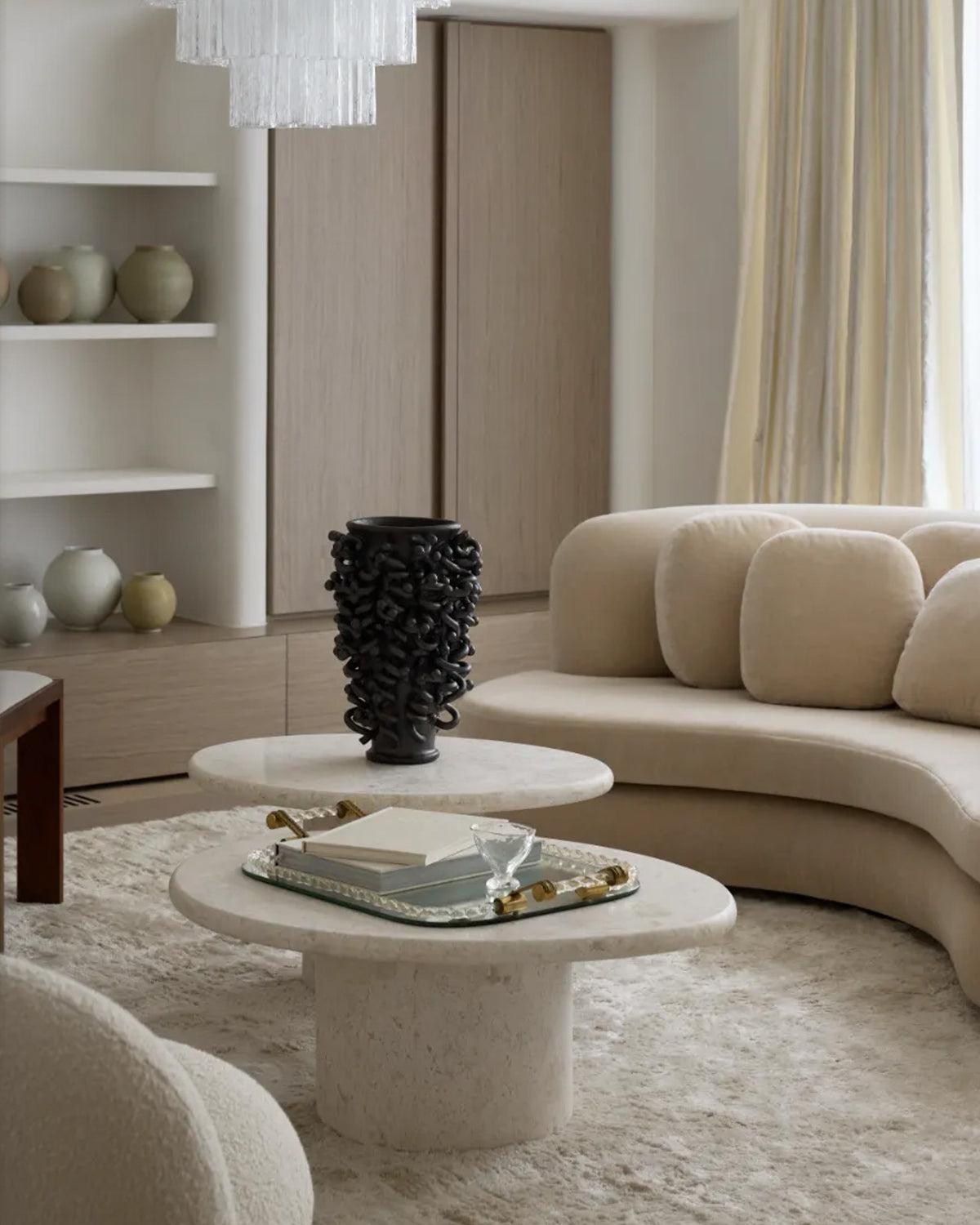 Round stone coffee tables styled in a living room