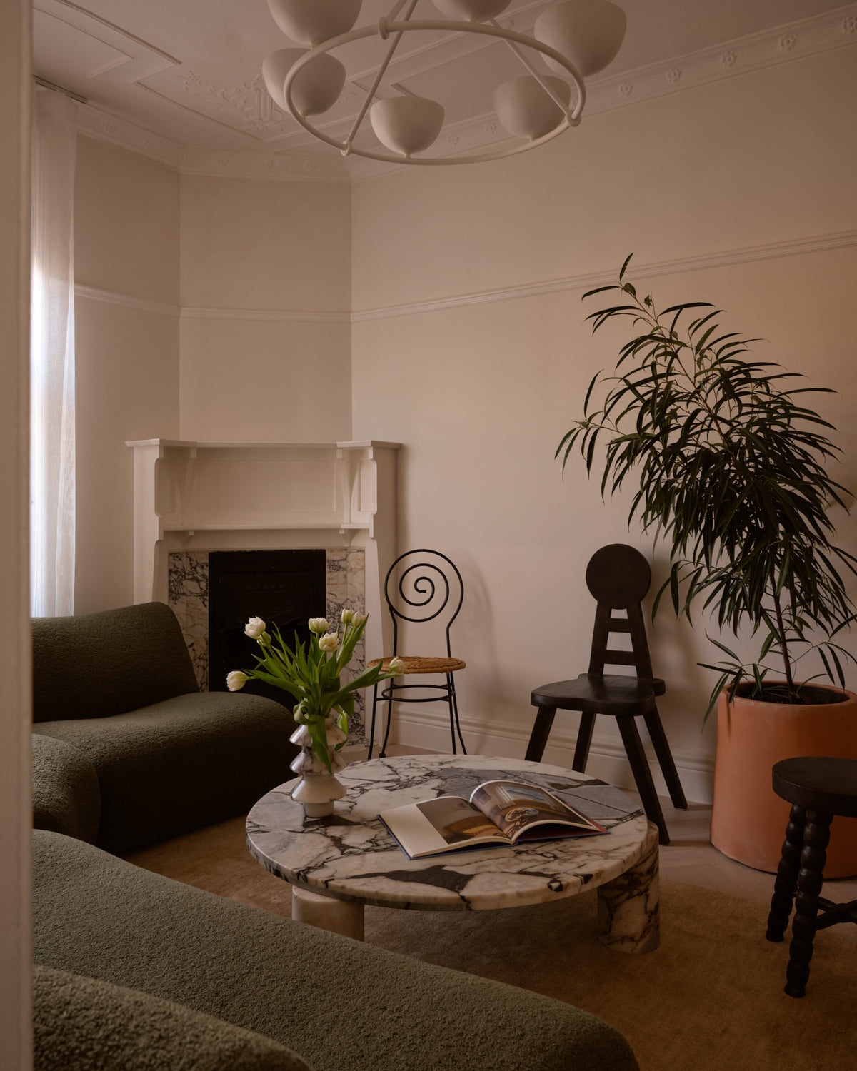 Round marble coffee table styled in a living room