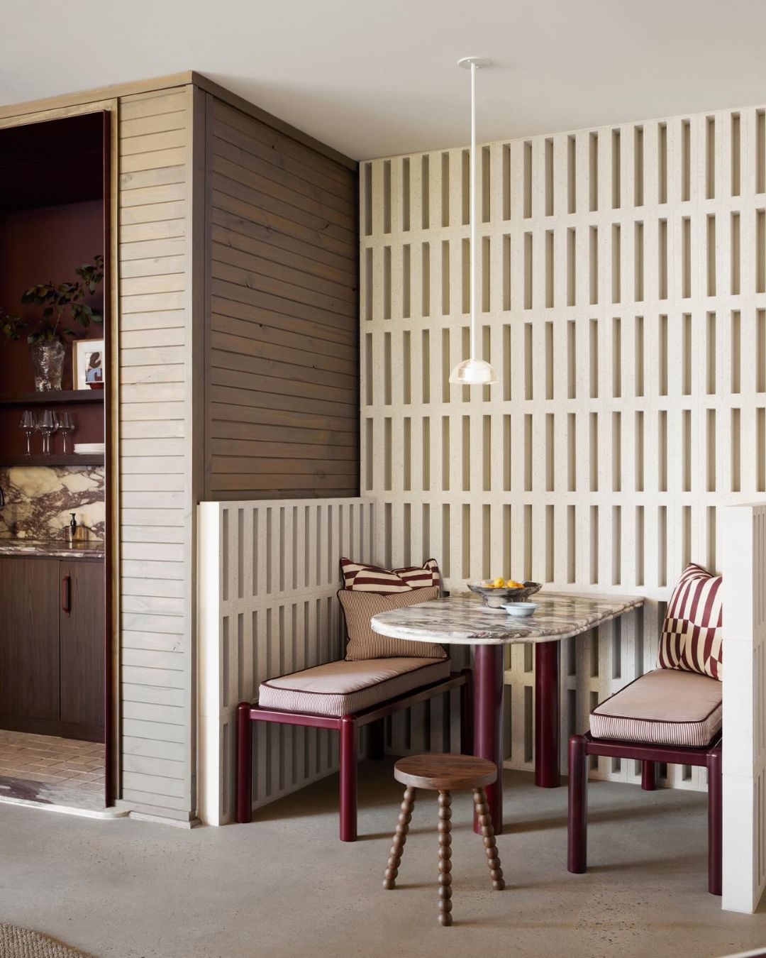 Modern dining area featuring Cleo walnut small stool