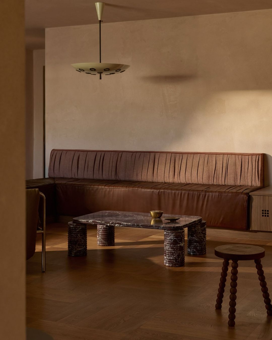 Living room featuring our rosa levanto marble coffee tableand wooden stool