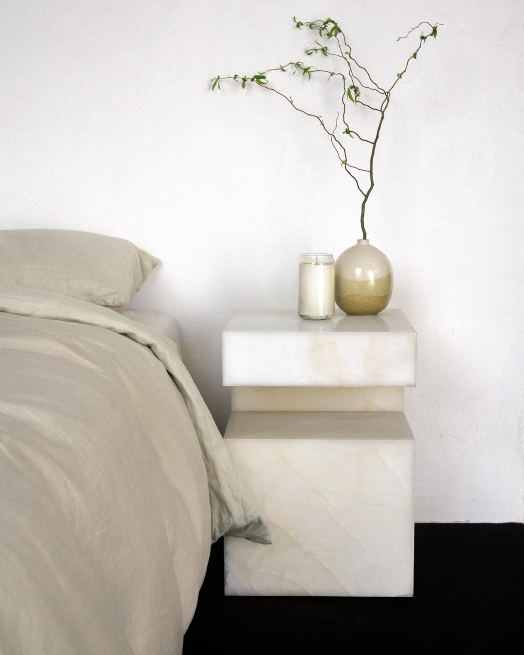 A white onyx marble bedside table