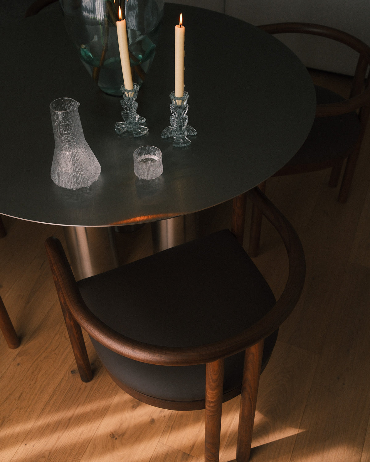 Stainless steel dining table styled with timber dining chairs