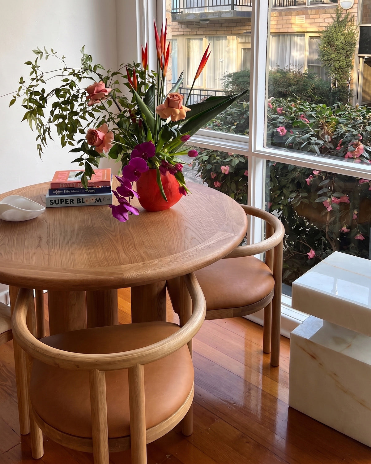 Round oak dining table styled in a dining room