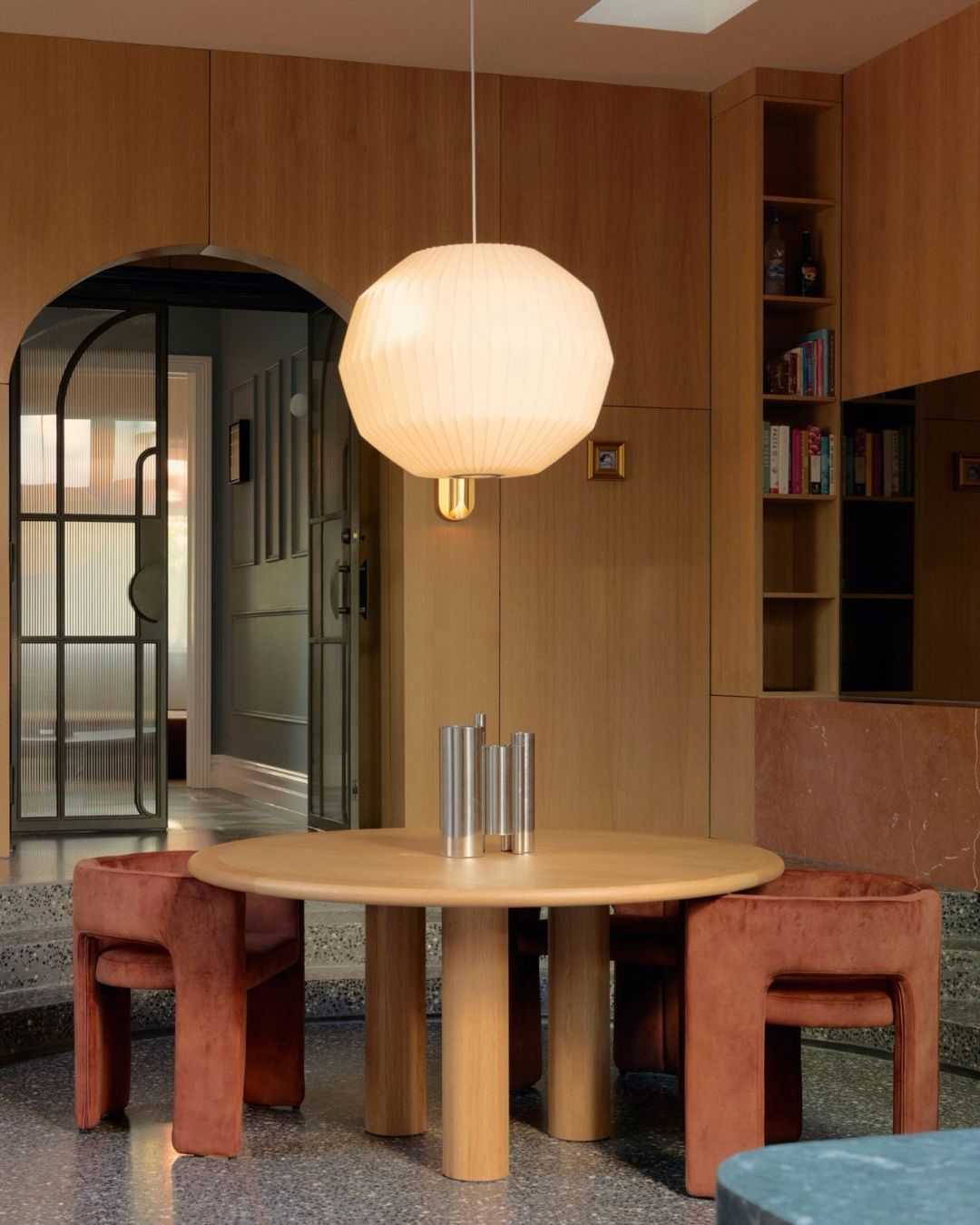 Round oak dining table styled in a dining room