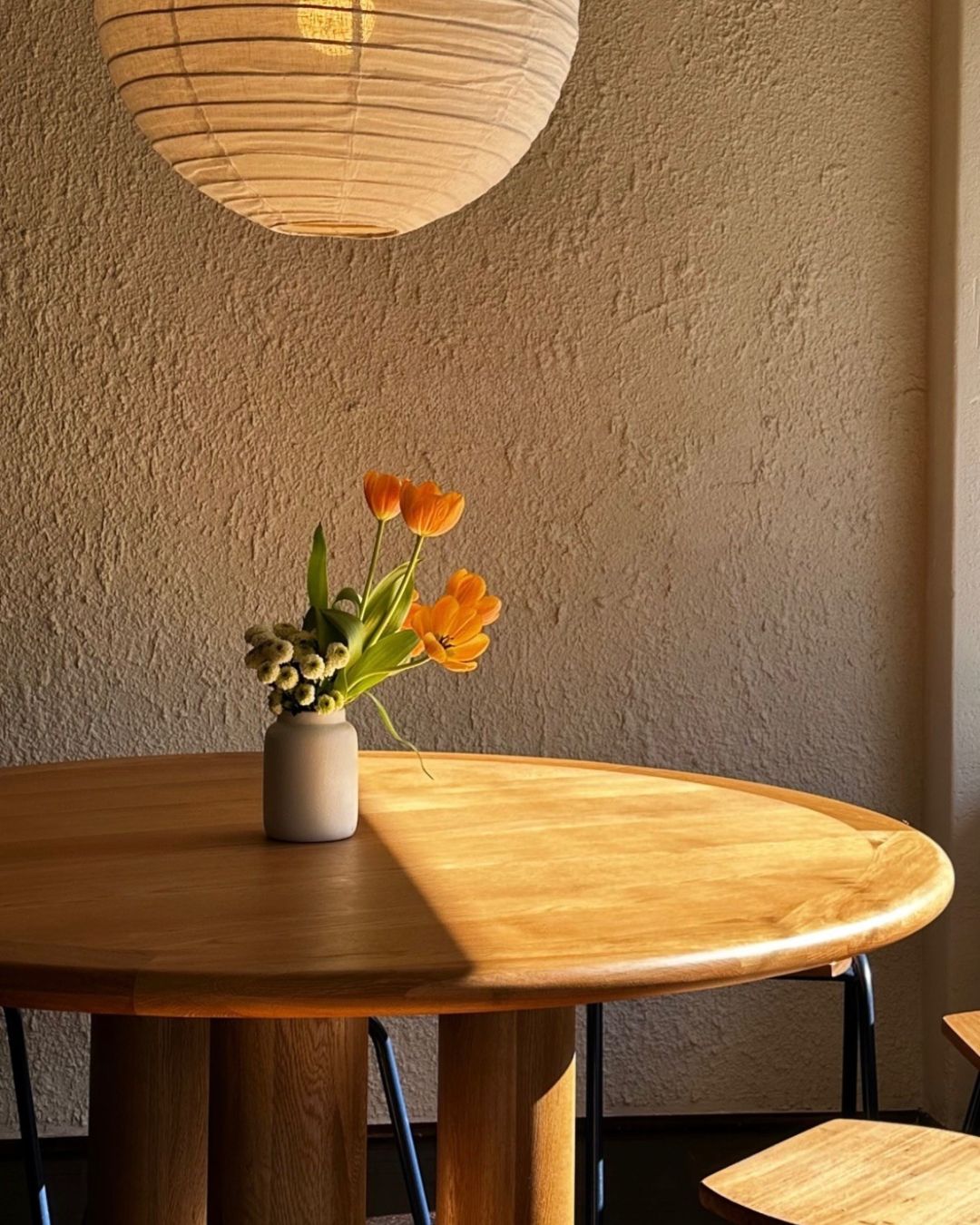 Round oak dining table styled in a dining room
