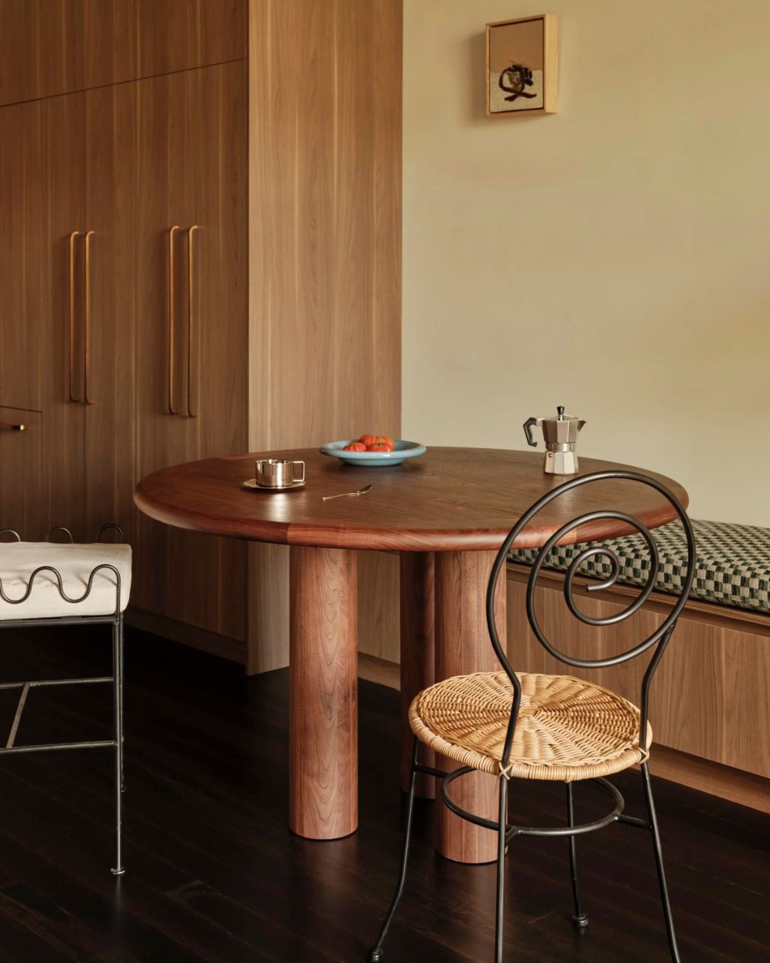 Round walnut dining table styled in a dining room