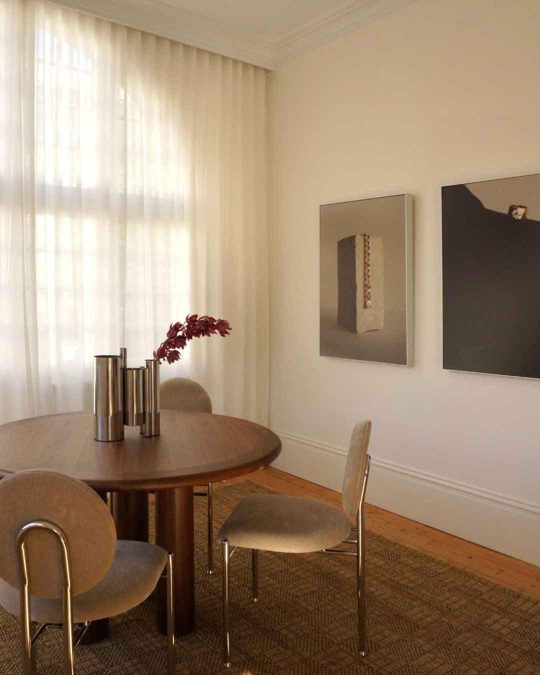 Round walnut dining table styled in a dining room