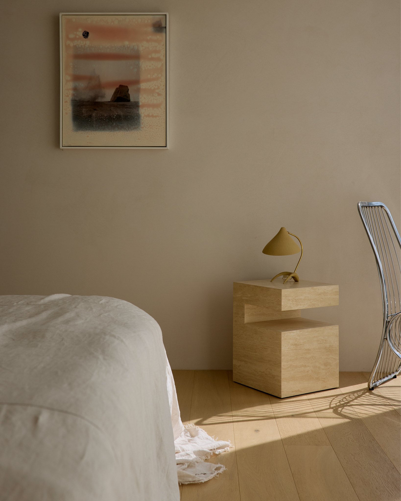 Bedroom styled with cream travertine side table