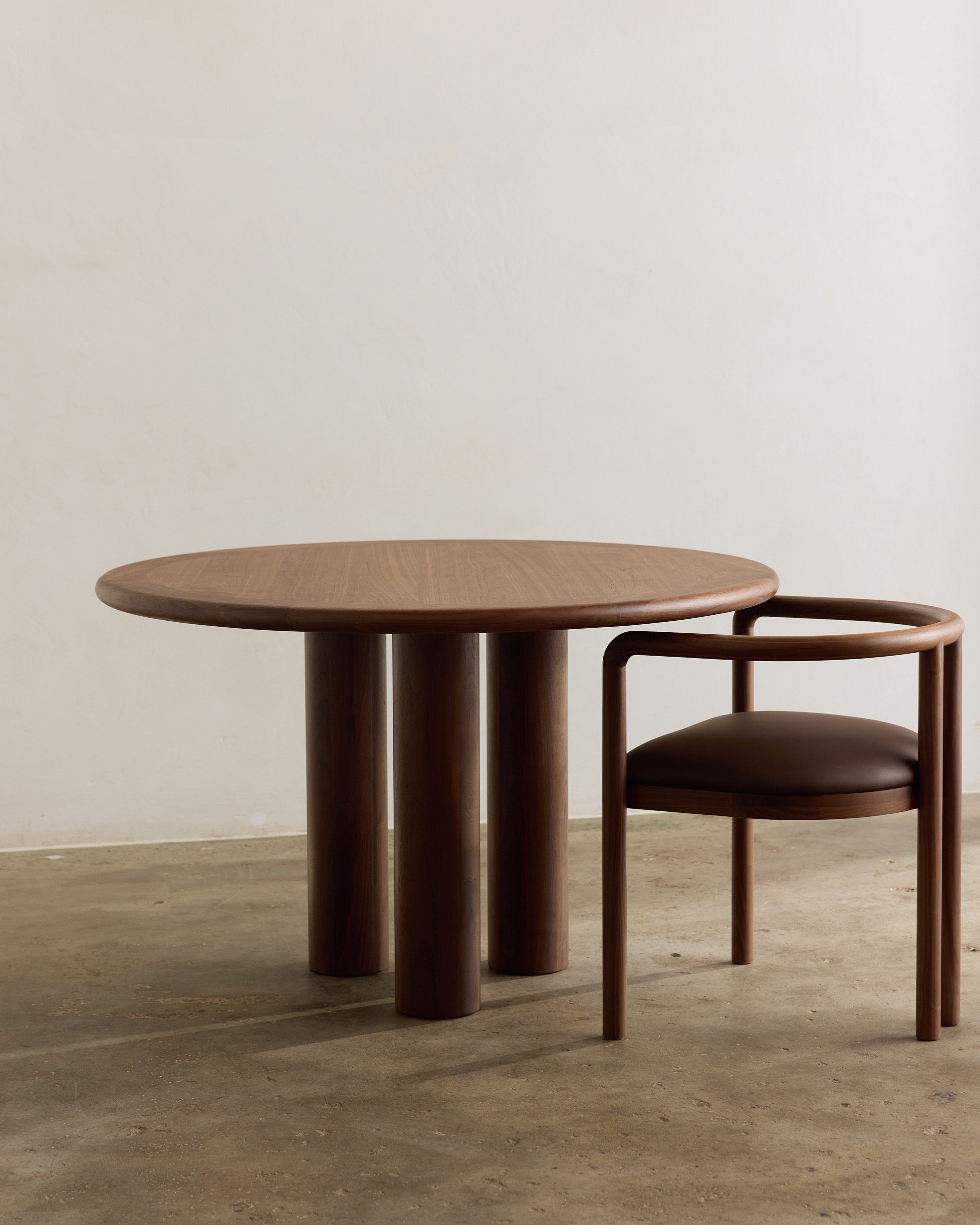 Round walnut timber dining table and chair