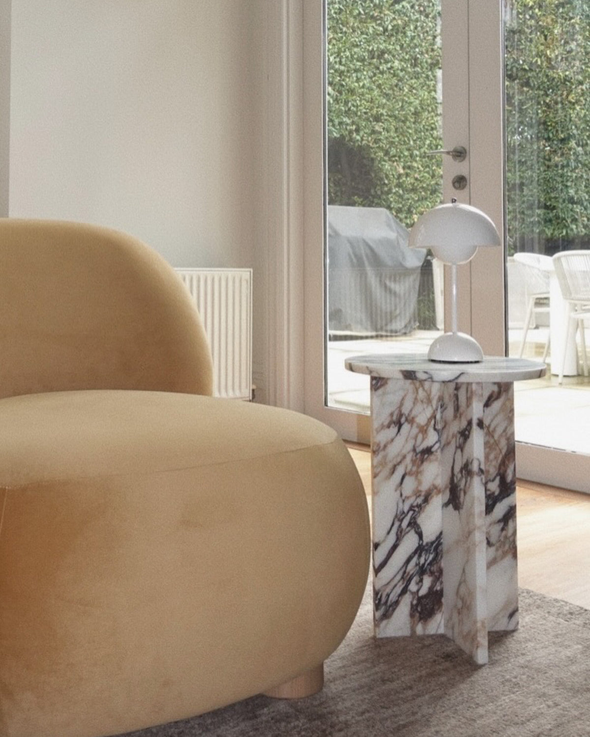 Small calacatta viola side table styled in a living room