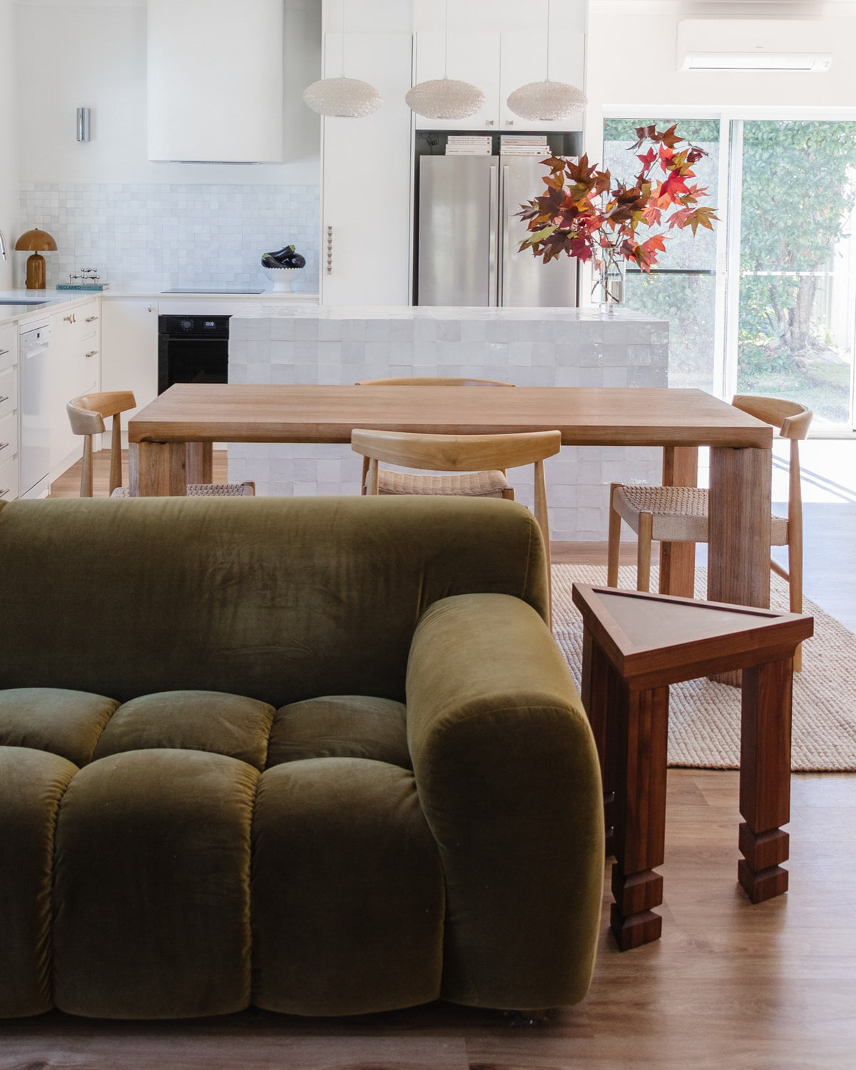 Wooden side table styled in a living room.