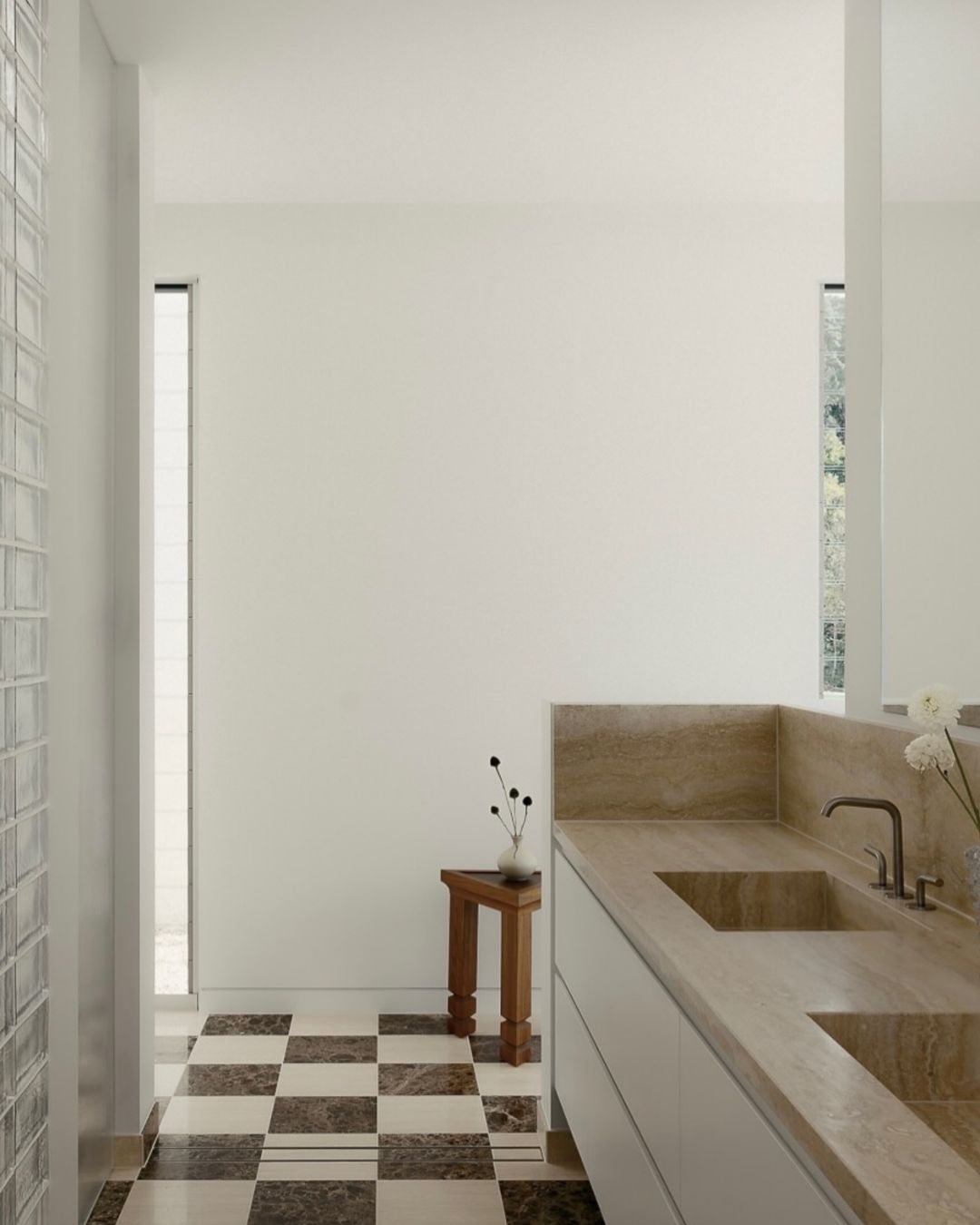 Modern bathroom with checkered floor and wooden side table