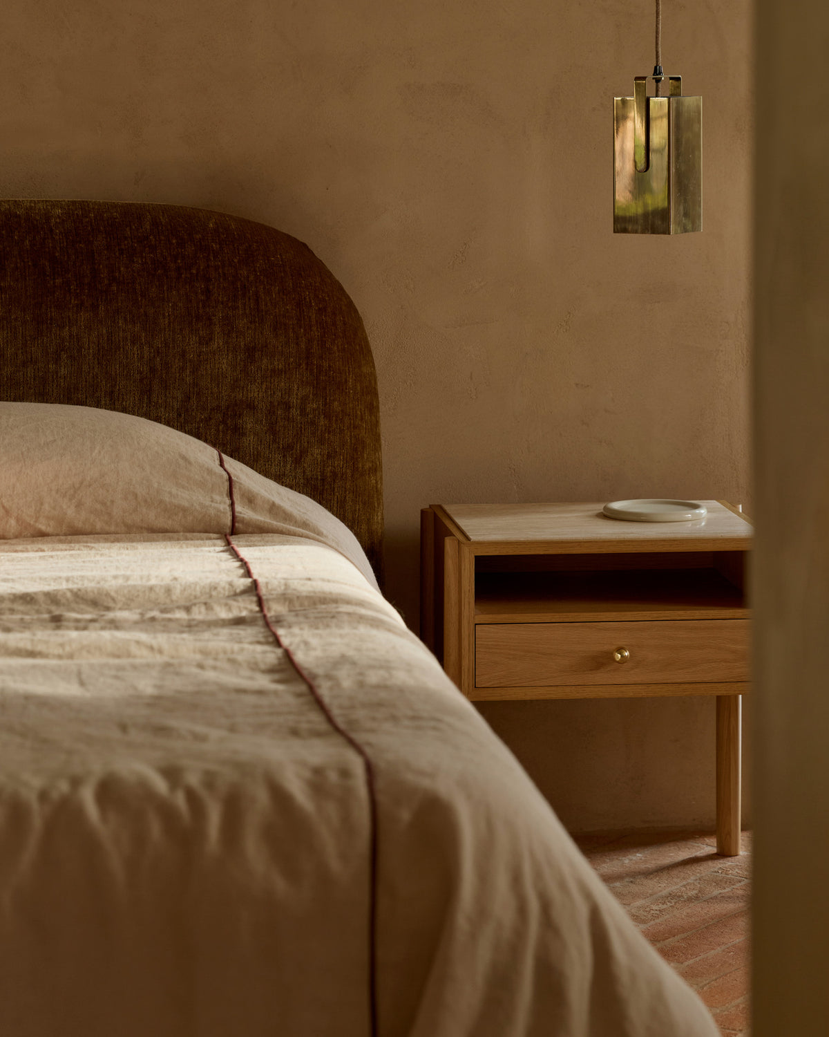 Oak and travertine bedside table styled