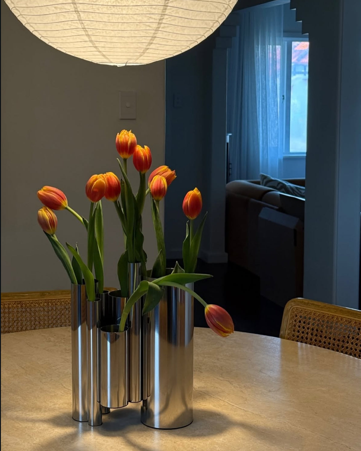 Stainless steel vase styled in a dining room
