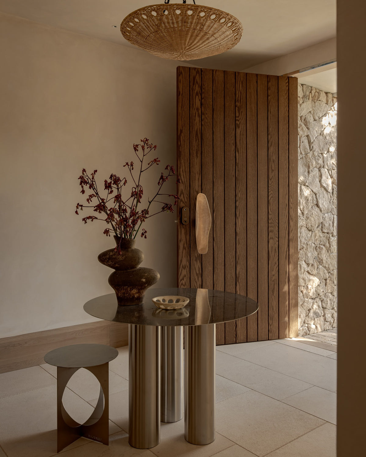 Stainless steel dining table and side table in an entryway