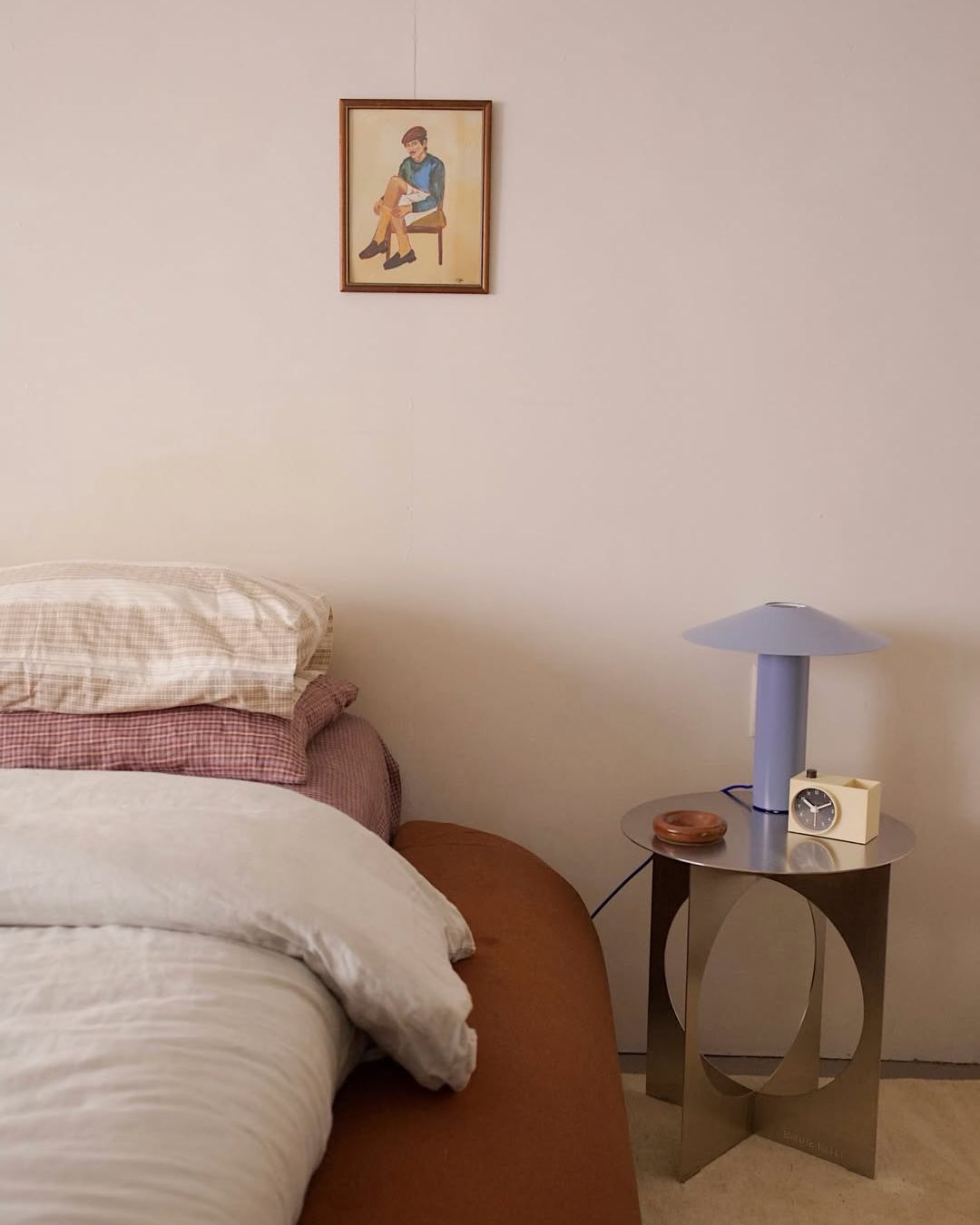 Stainless steel bedside table styled in a bedroom