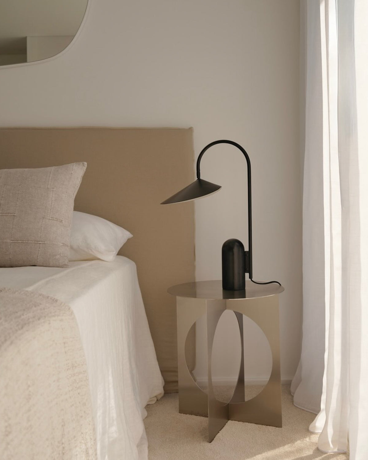 Stainless steel bedside table styled in a bedroom