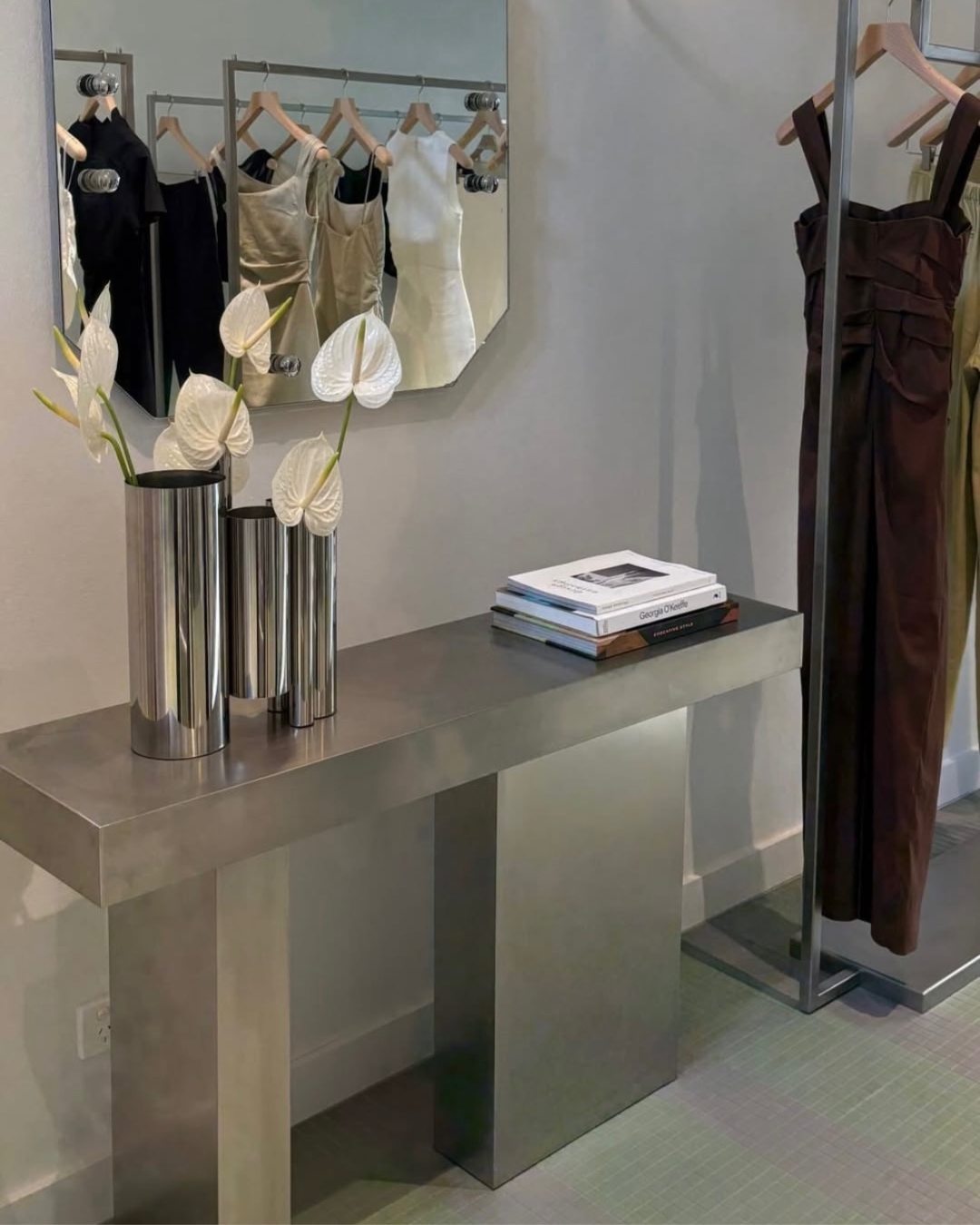 Stainless steel console table styled in a boutique.
