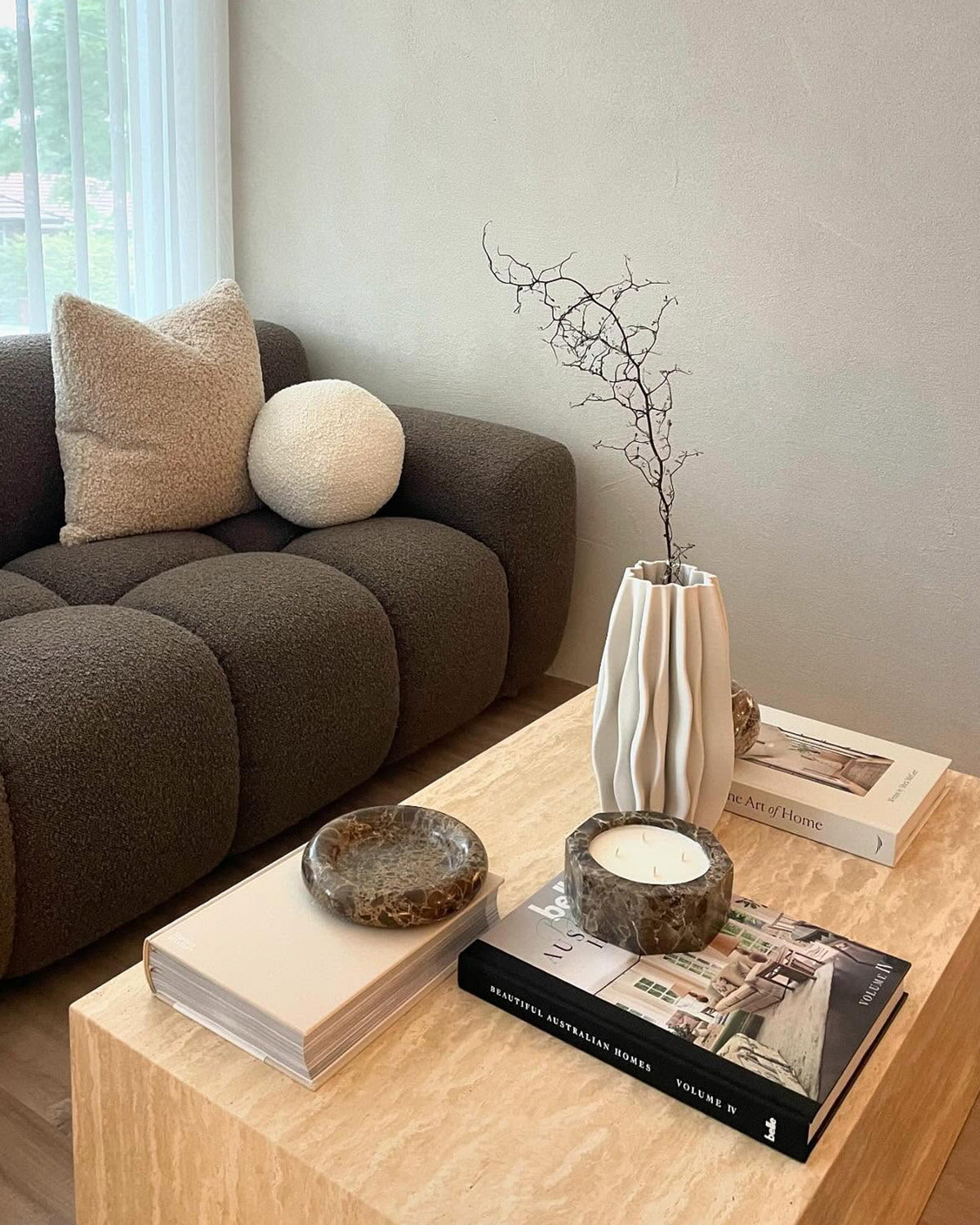 Cream travertine coffee table styled