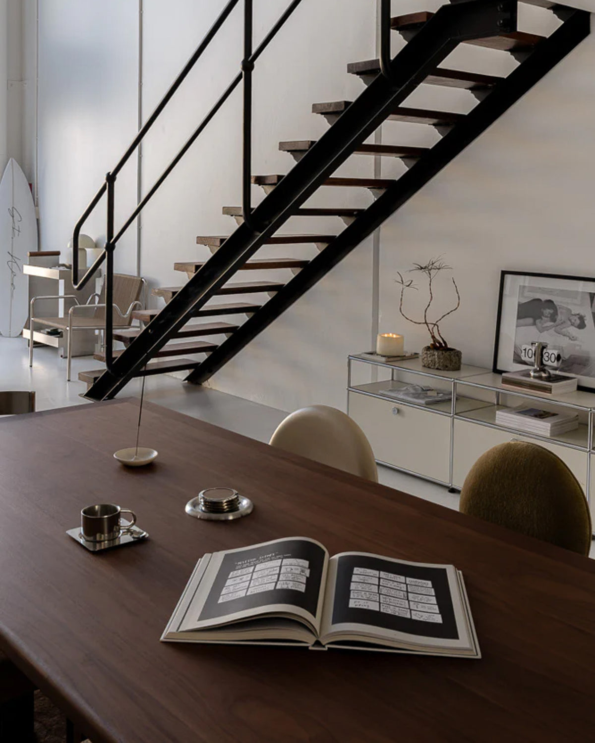 Walnut timber dining table styled in a studio